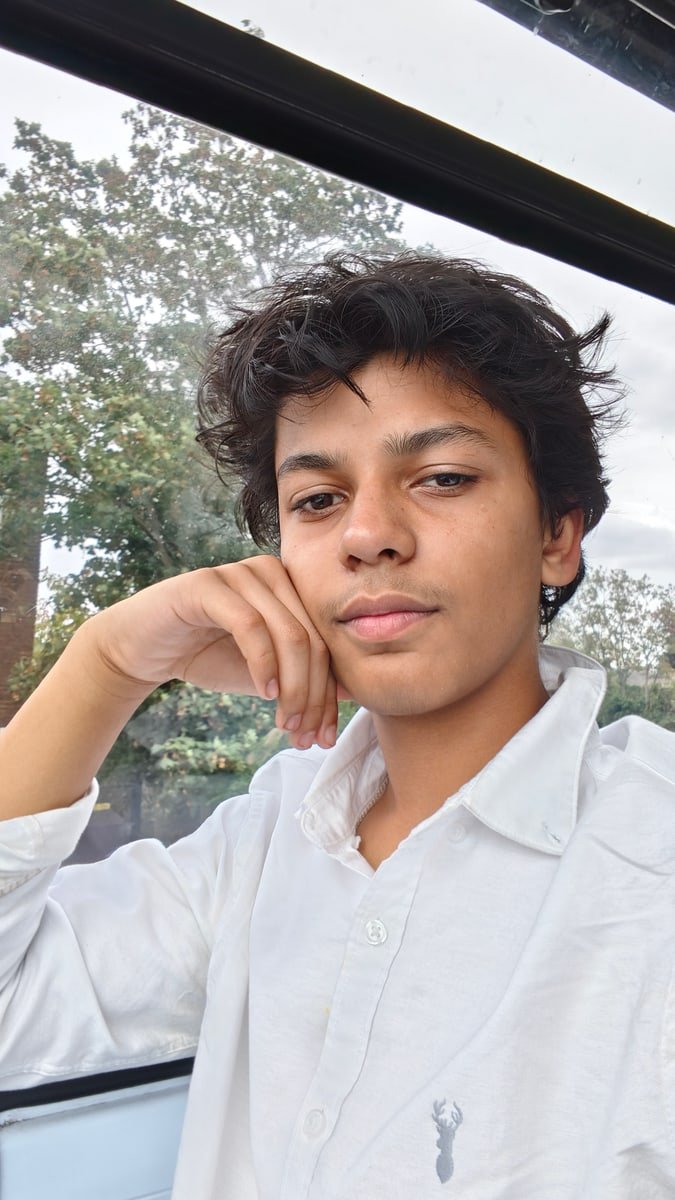 Aarush beside a window in natural daylight